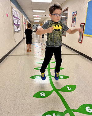 Boy playing hopscotch in the hallway