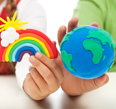Students holding a clay globe and rainbow
